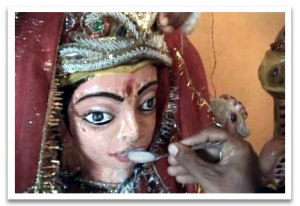 Milk being offered to a sacred image of a Goddess in India