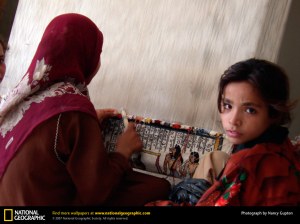 Modern Egyptian woman and girl weaving one of the ancient patterns