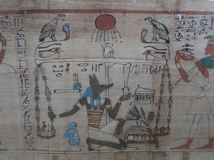 On one side of the balance, the heart, on the other the Feather of Truth; note the chains made of the Knot of Isis and the Djed of Osiris