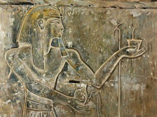 A king offering incense and pouring a libation